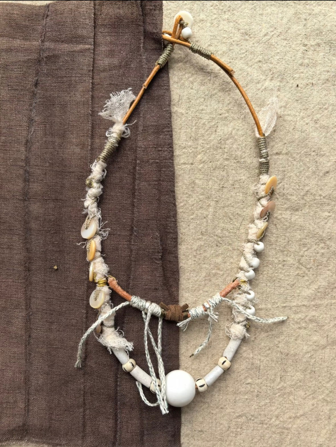 Tidal Relic one-of-a-kind necklace made from twig, shell fragments, wrapped textile, cord, and beads
