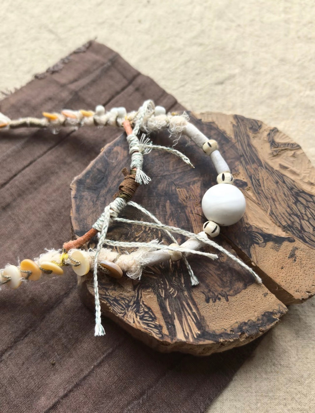 Detail of shell fragments and wrapped textile on Tidal Relic statement necklace