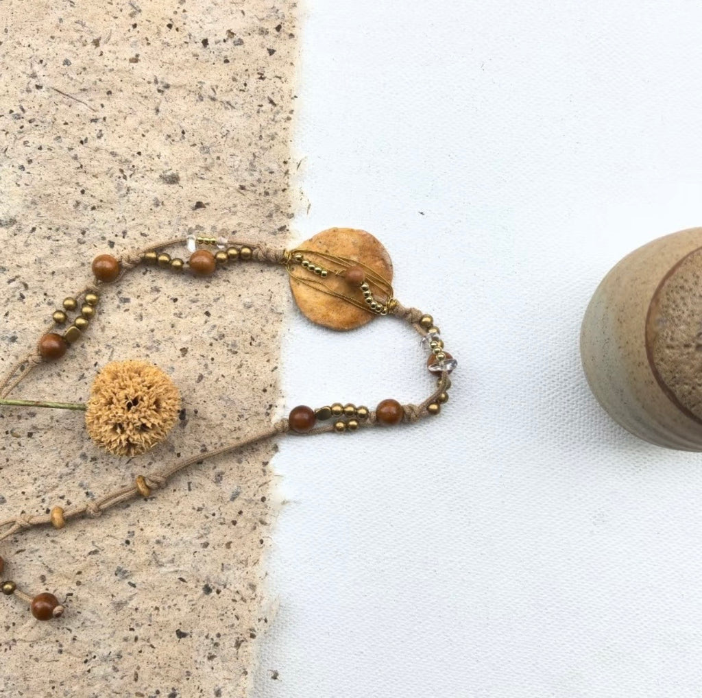 Handmade nummulite fossil bracelet styled on the wrist in an earthy boho look