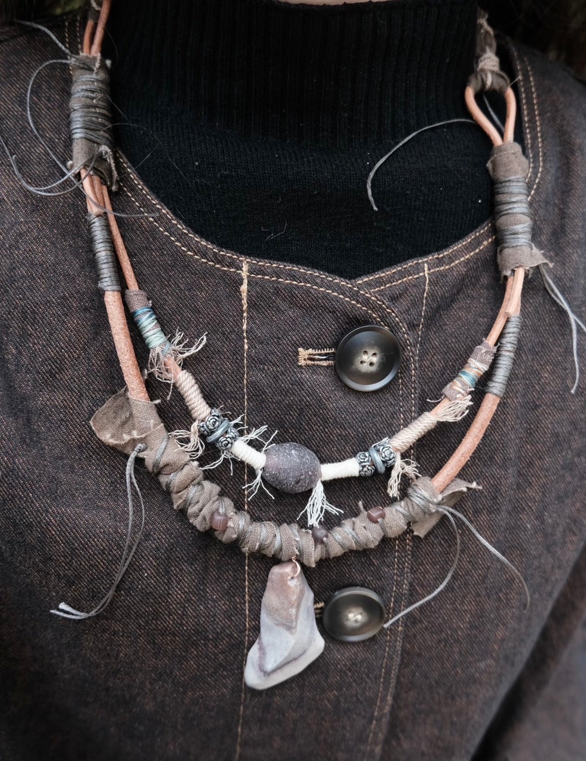Rustic handmade pendant necklace worn with dark clothing